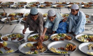 Boys prepare food at a Pakistan mosque before sunset, when Muslims observing Ramadan break the fast